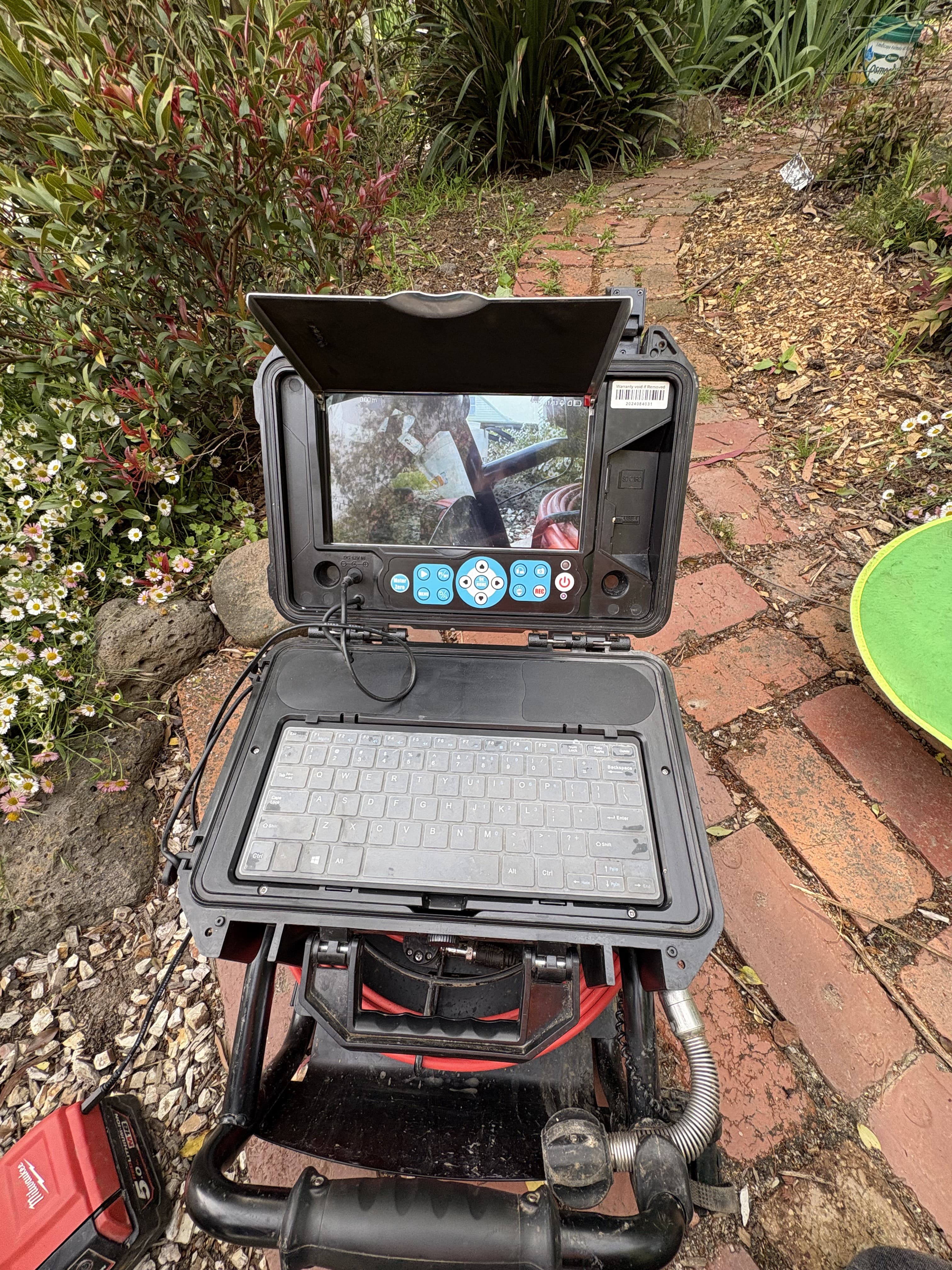 CCTV drain inspection monitor recording a pipe run