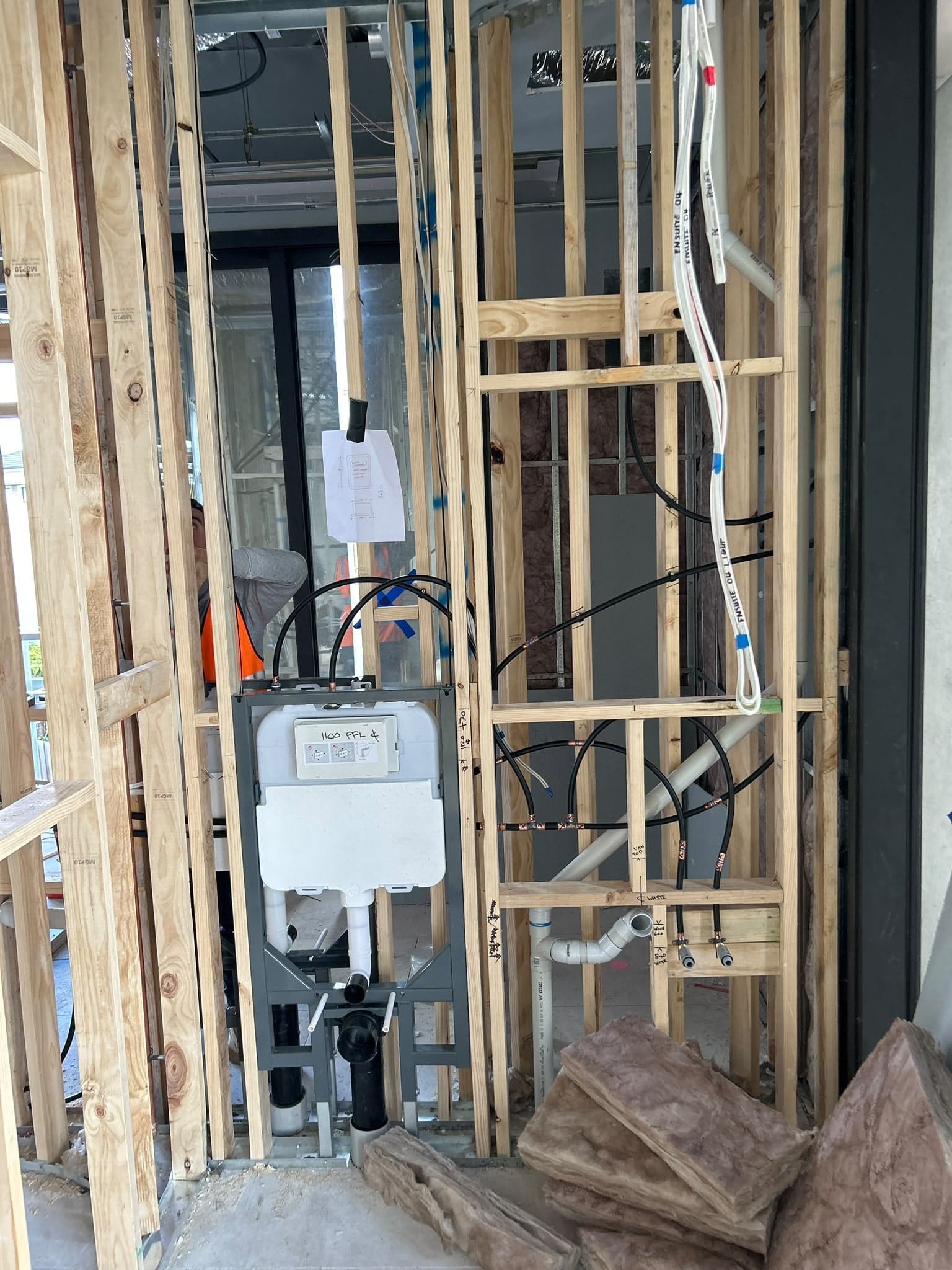 In-wall toilet cistern and pipework roughed in to a timber wall frame