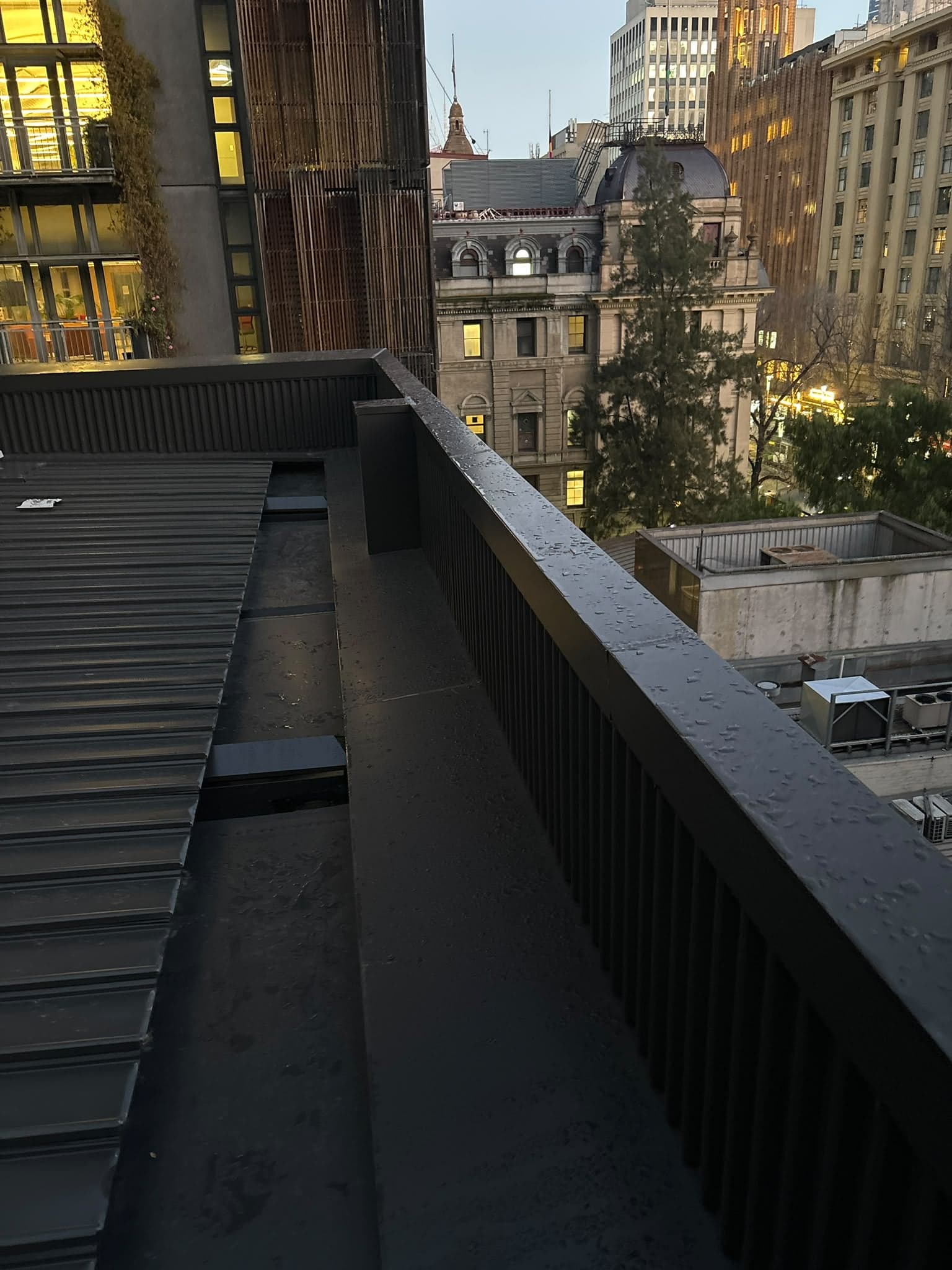 Metal roof and box gutter on an inner-city apartment building