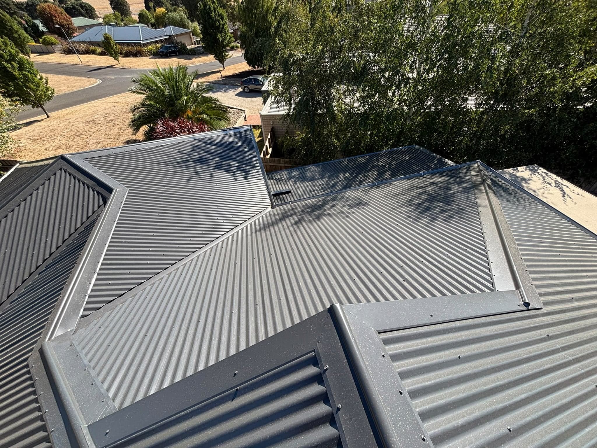 Metal hip and valley roof with new flashings