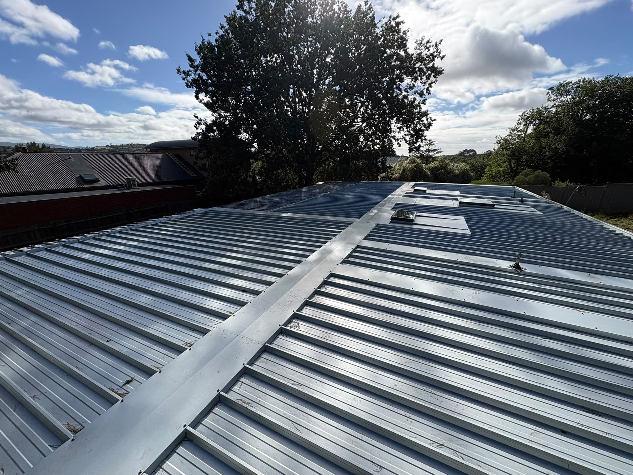 New corrugated metal roof sheeting with a ridge capping by Prava