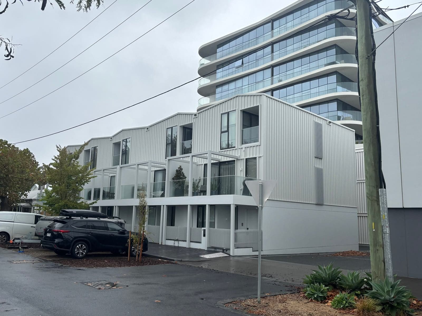 New townhouses with metal roofing and wall cladding on an inner-city street